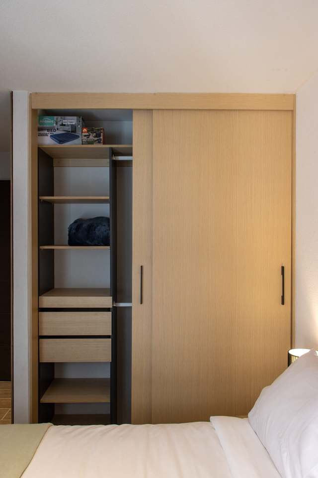 Clóset empotrado con puerta corrediza, repisas y gavetas